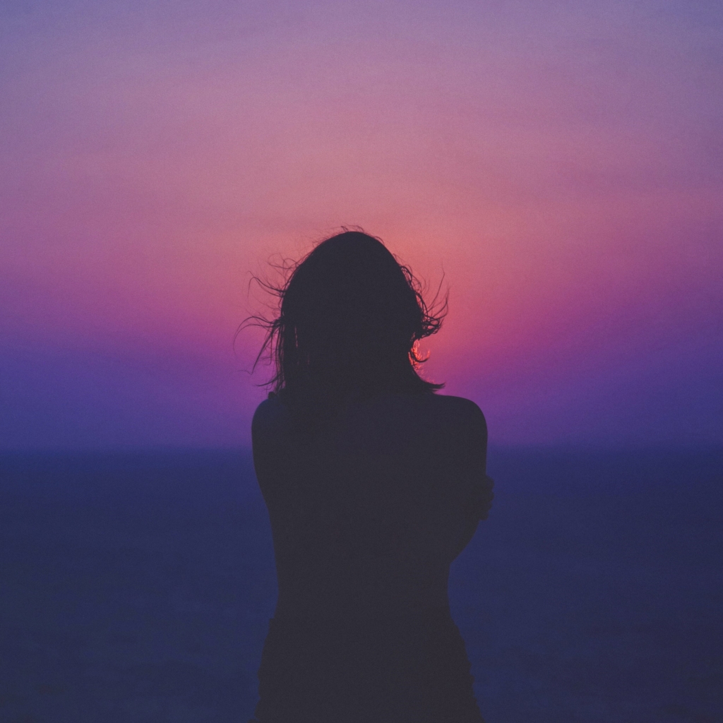 Where to find your happy place, water signs - silhouette of woman in front of blue purple sunset