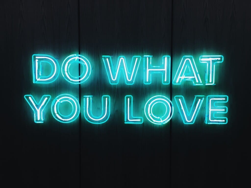Blue neon sign that reads "DO WHAT YOU LOVE"