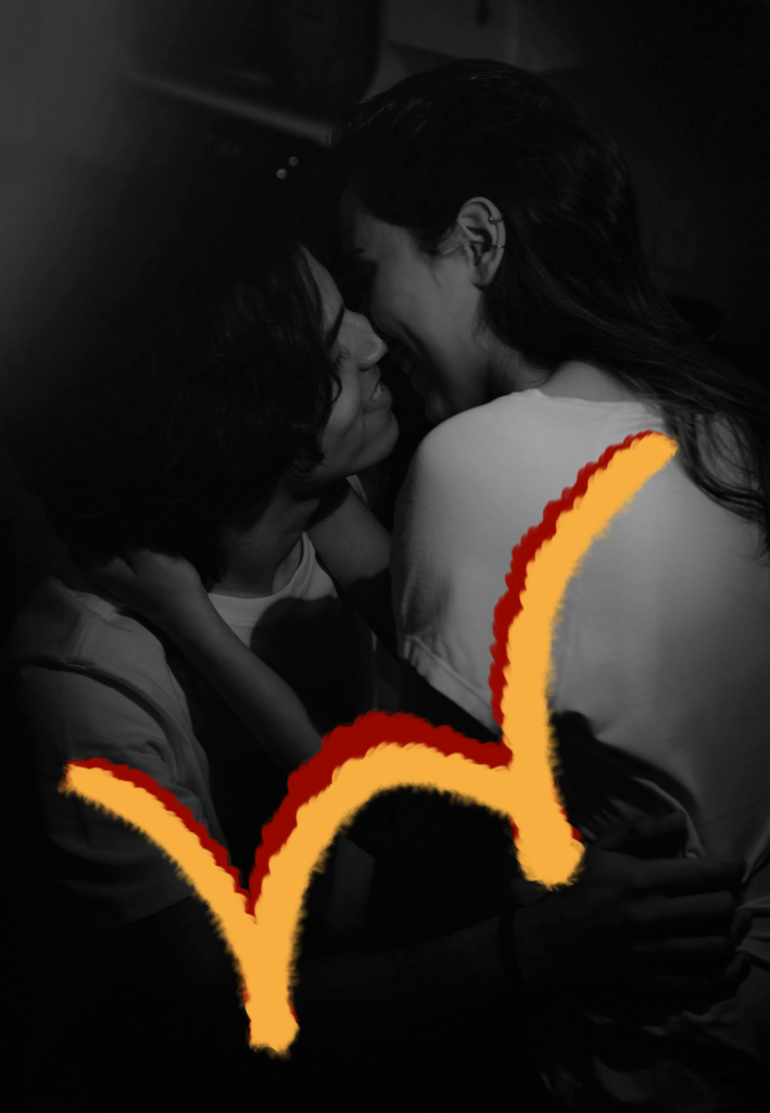 A couple kissing with red and yellow swirls on picture leo man and cancer woman