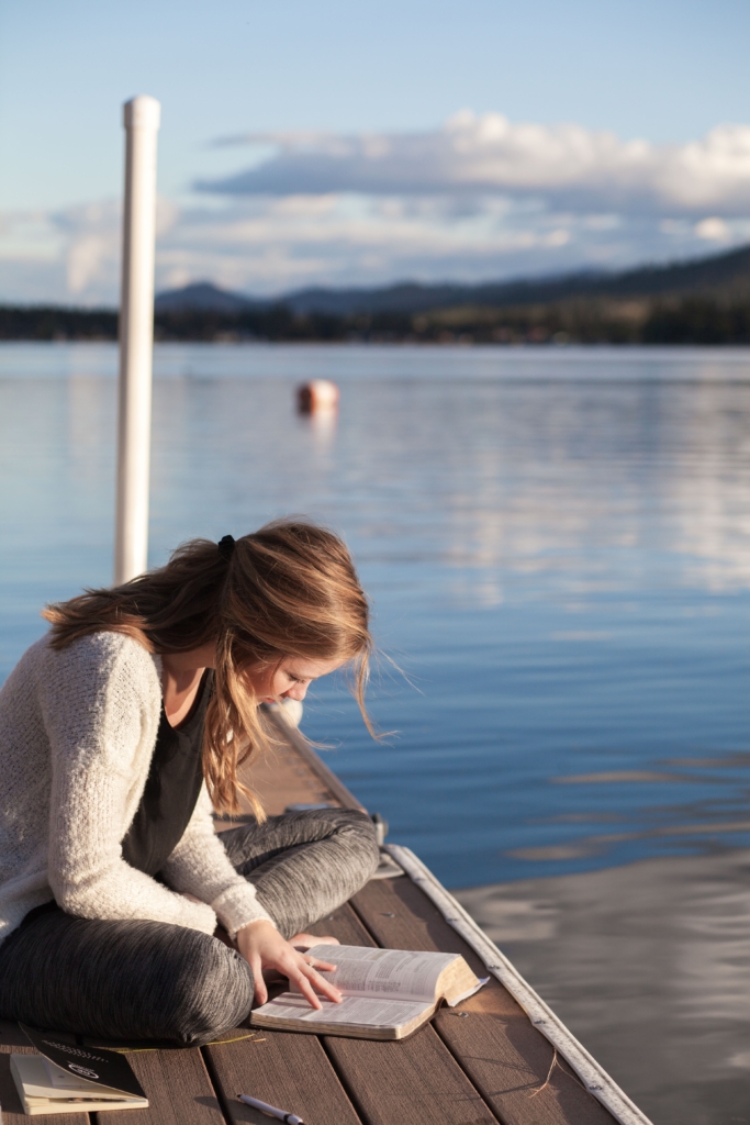 Pisces - fantasy - woman sitting on small pier while reading a book