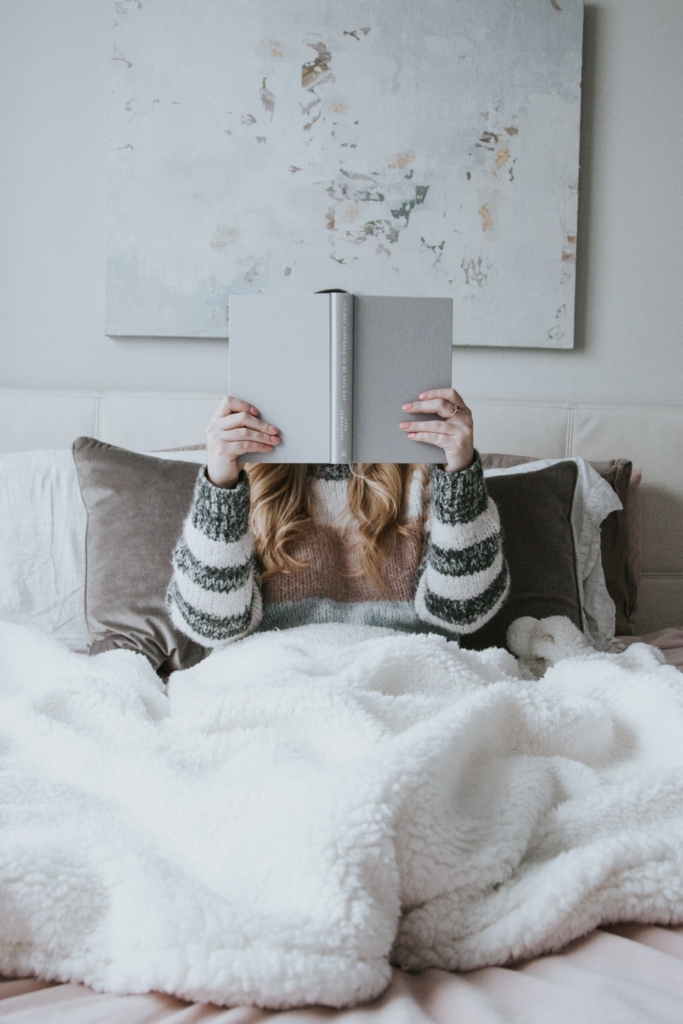 Cancer - Romance - woman sitting in bed reading a book