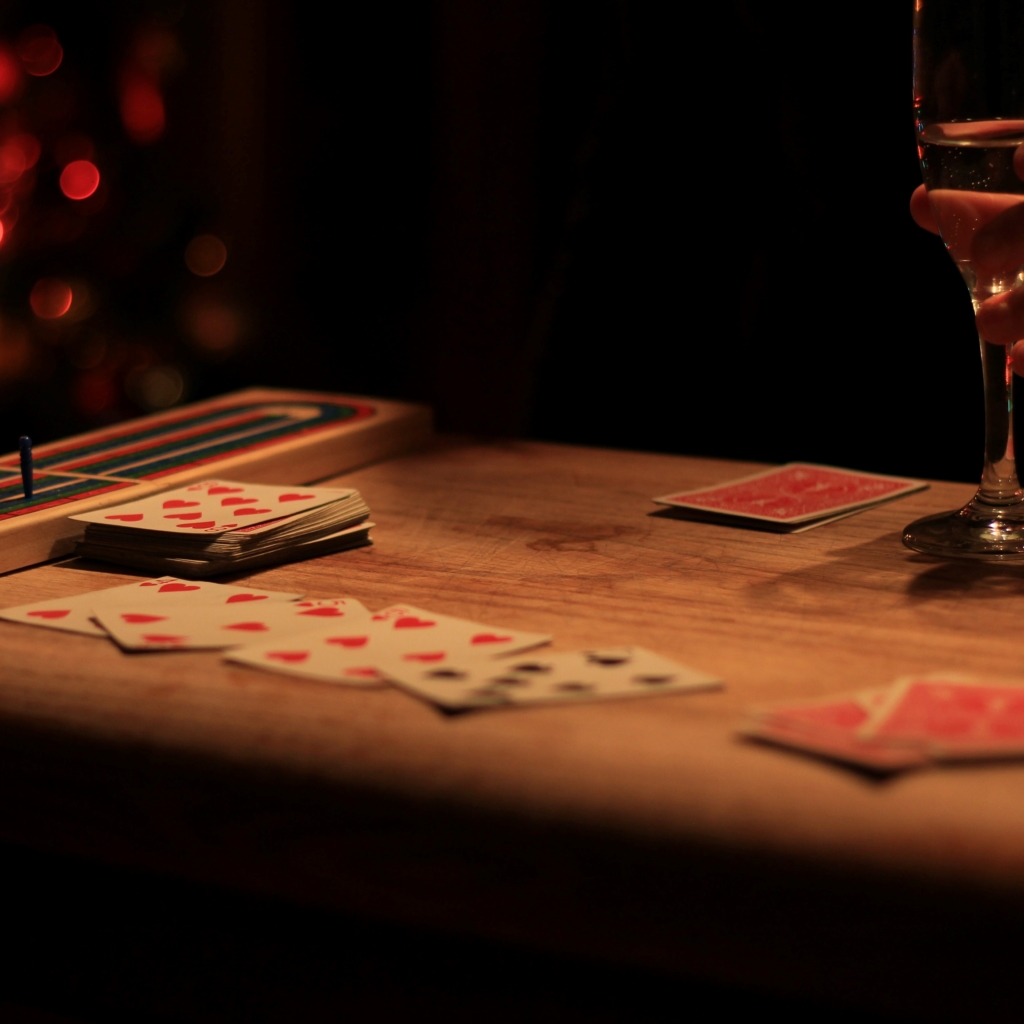 Host a game night - table with wine and playing cards 
